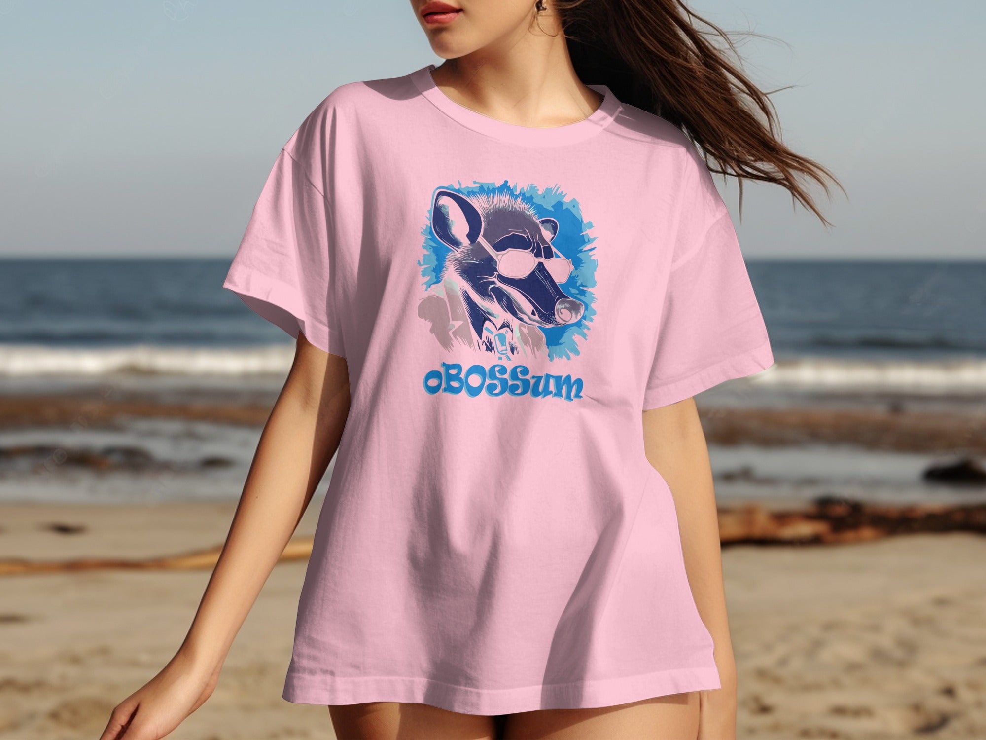 Pink t-shirt with graphical design of opossum wearing sunglasses and text OBOSSum.