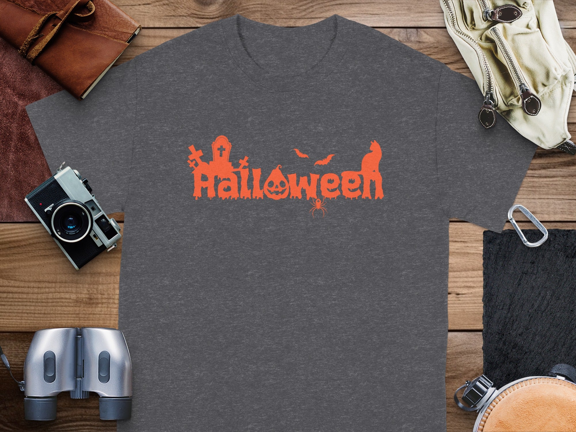Grey t-shirt with orange Halloween text featuring a pumpkin, bats, cat, and spider.