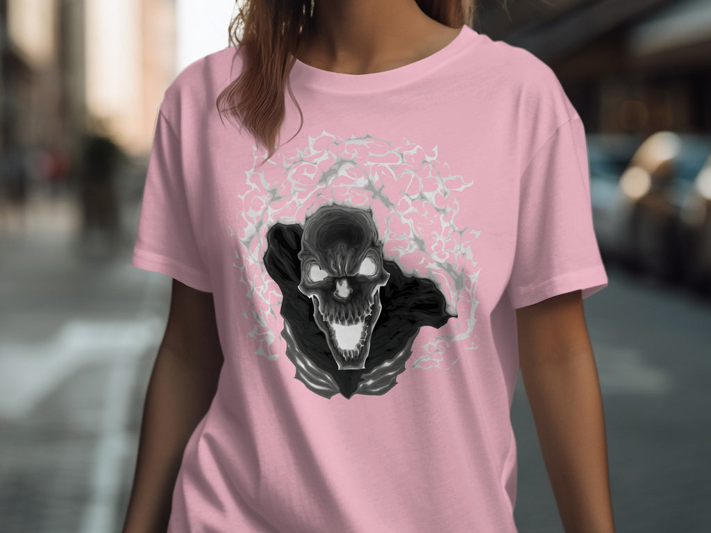 Pink t-shirt with a black and gray skull graphic surrounded by abstract shapes.