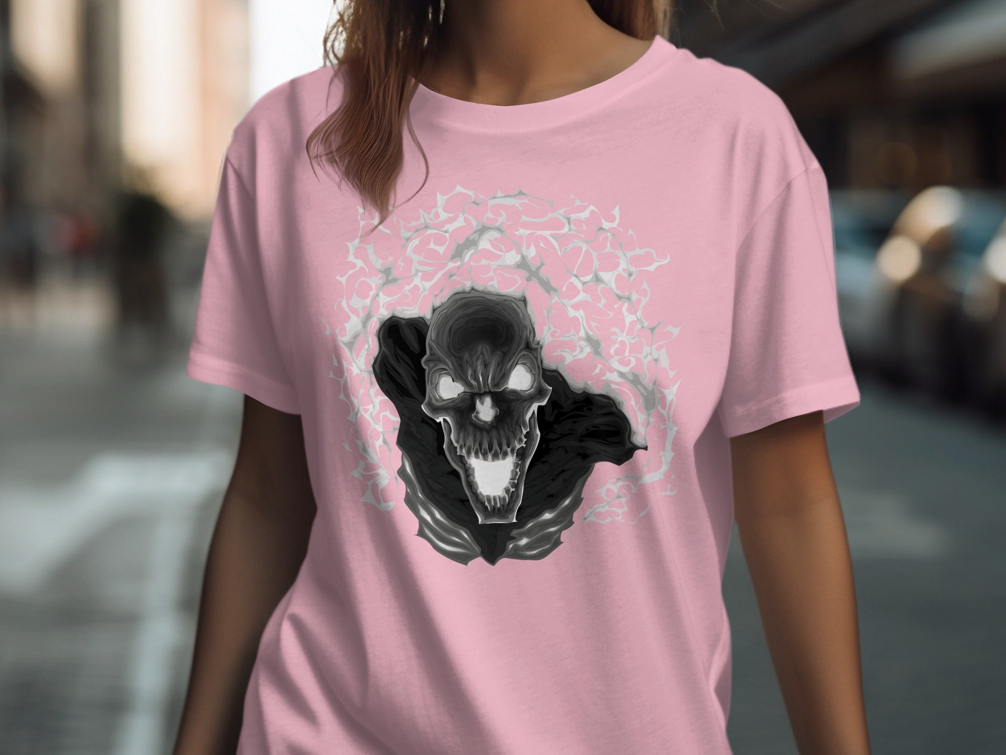 Pink t-shirt with a black and gray skull graphic surrounded by abstract shapes.