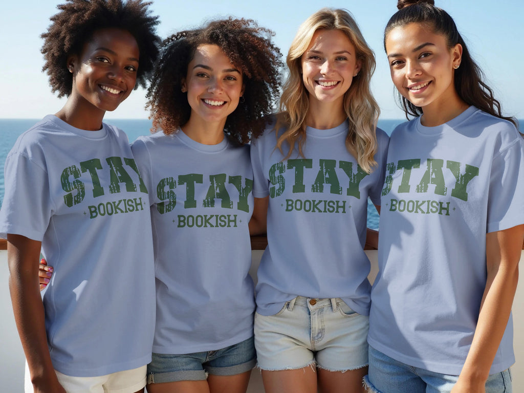 Four women in light blue t-shirts with green "STAY BOOKISH" text stand together.