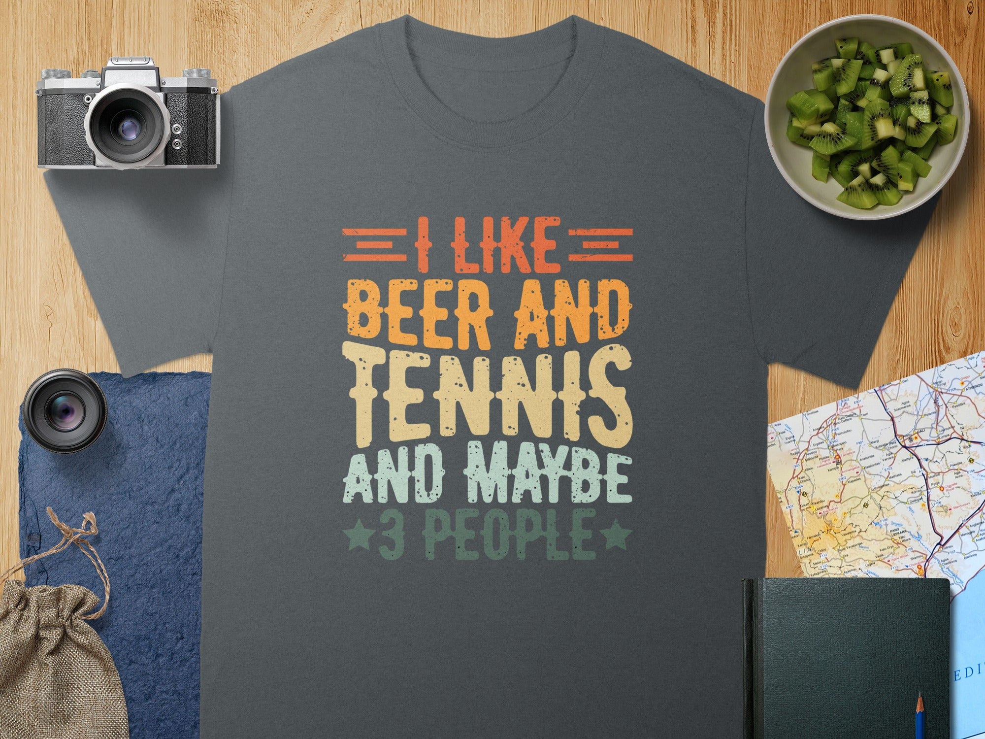 Dark grey t-shirt with text "I LIKE BEER AND TENNIS AND MAYBE 3 PEOPLE".