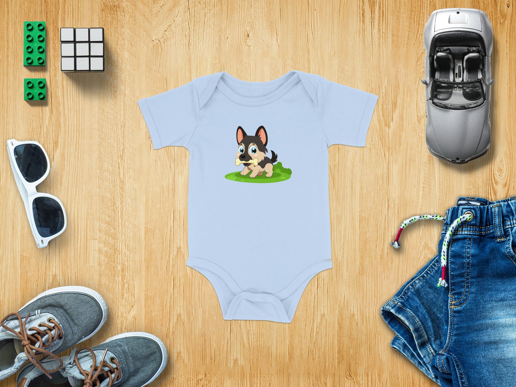 Light blue baby onesie with a cartoon puppy graphic holding a bone.