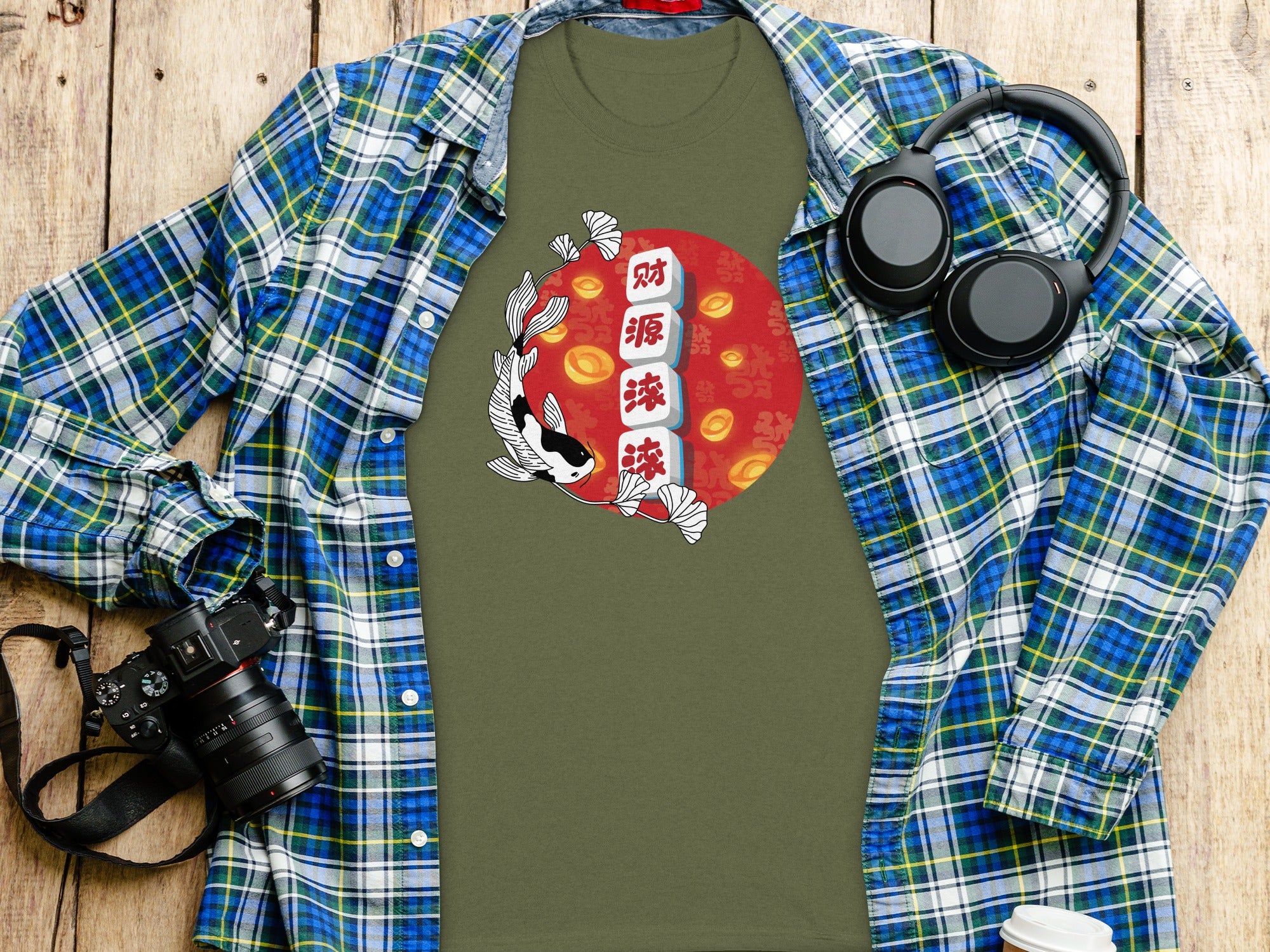 Green t-shirt with koi fish and Chinese characters design, layered under plaid shirt.
