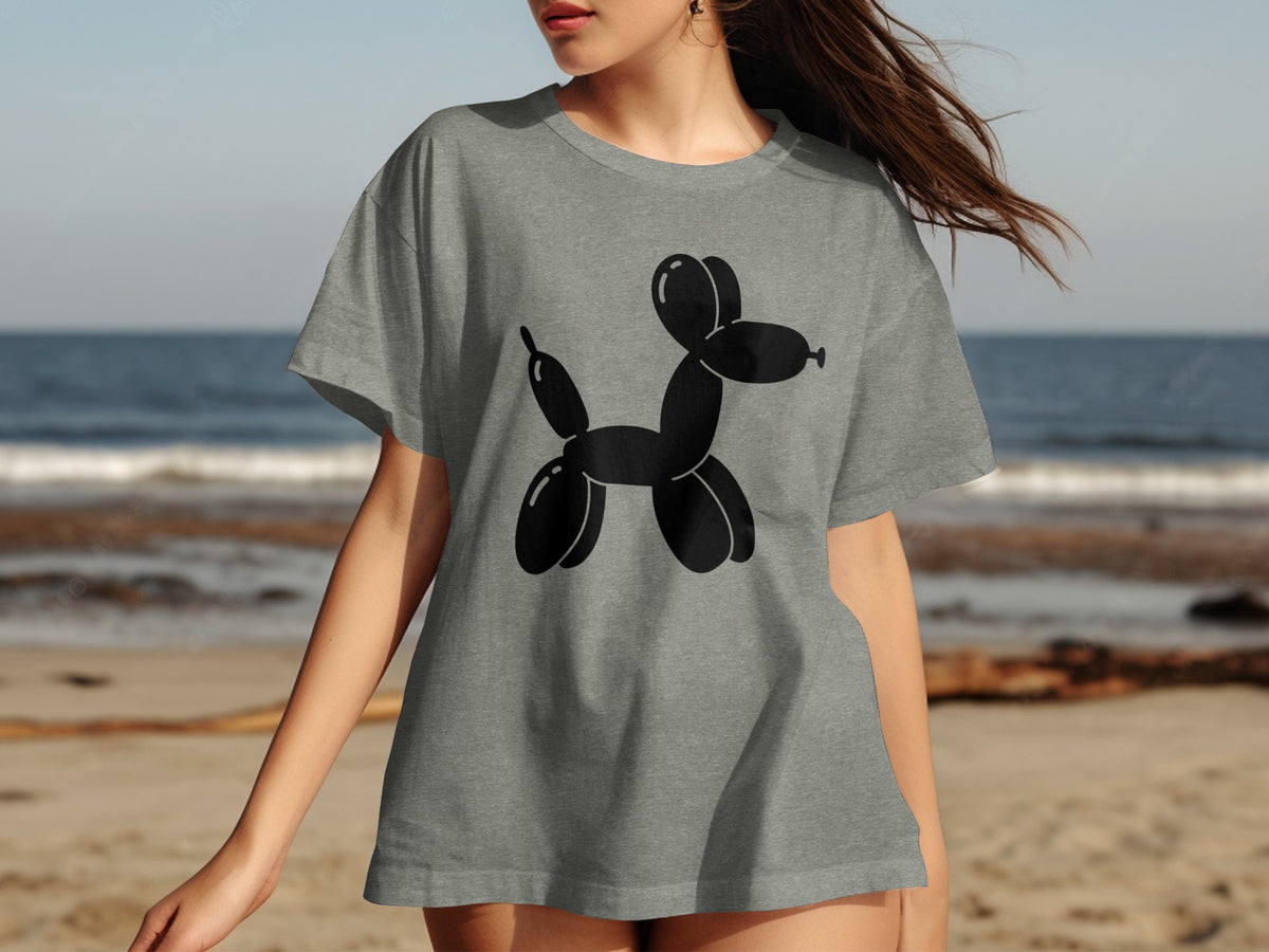 Grey t-shirt with a black balloon dog graphic on a beach background.