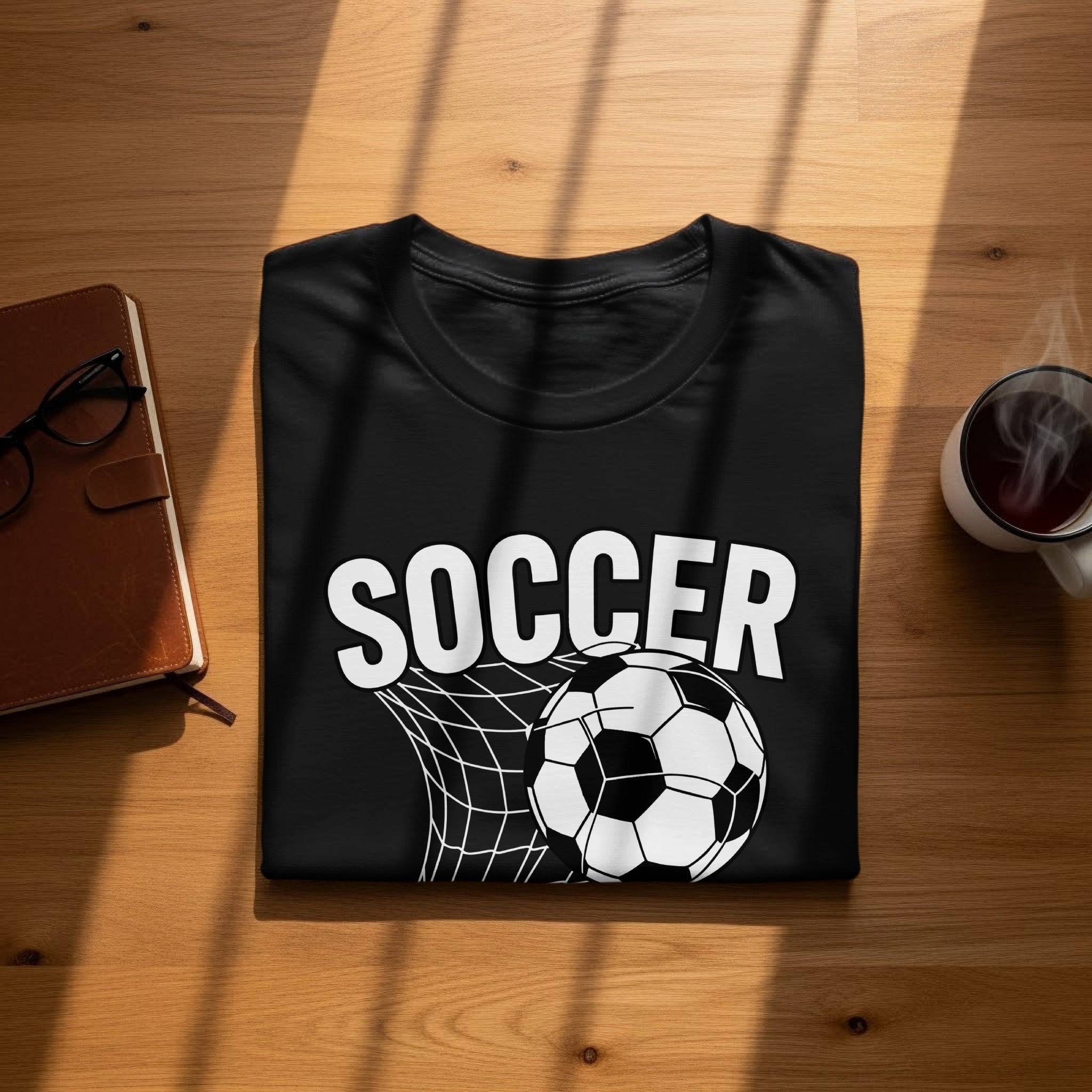 Black t-shirt with "SOCCER" text and a soccer ball in a net design.