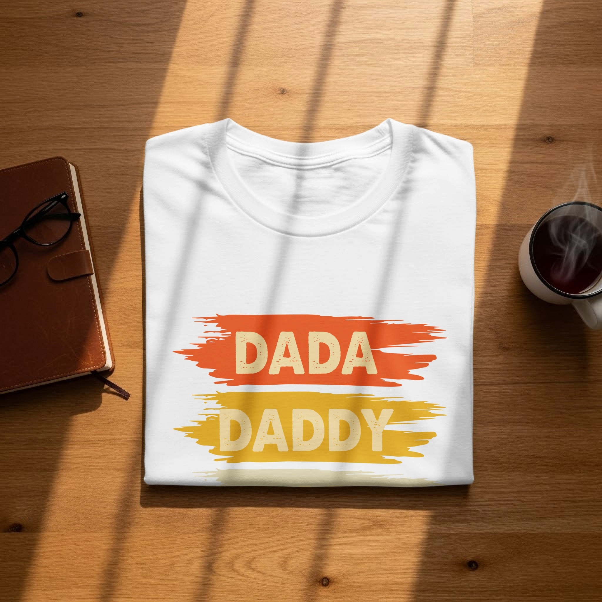 White t-shirt with "DADA" and "DADDY" text in distressed paint strokes.