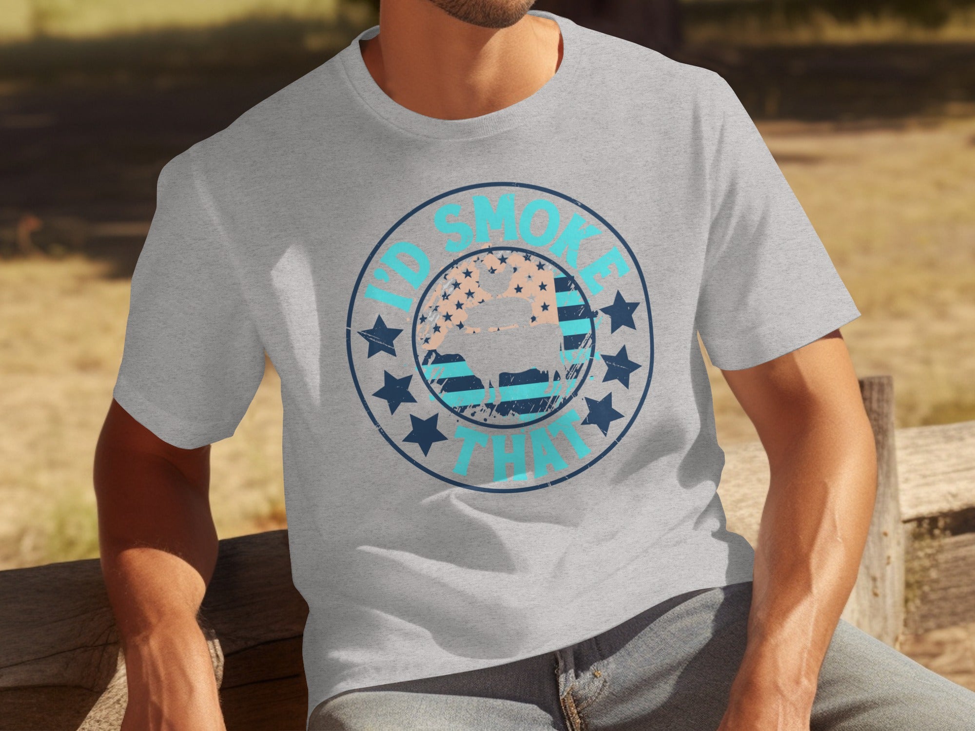 Grey t-shirt with circular graphic featuring "I'd Smoke That" text and a steer silhouette.