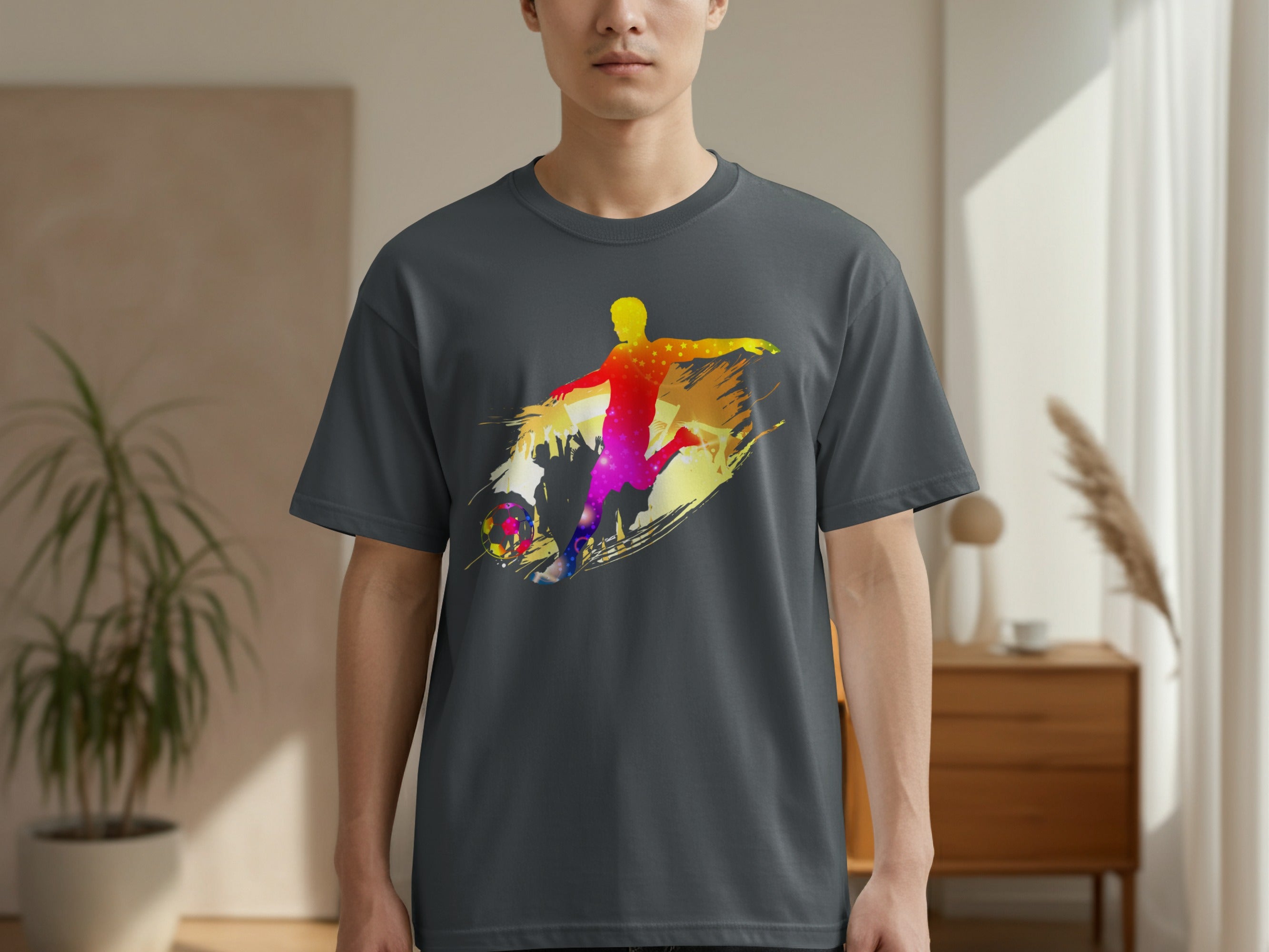Dark grey t-shirt with colorful abstract graphic of a soccer player kicking a ball.