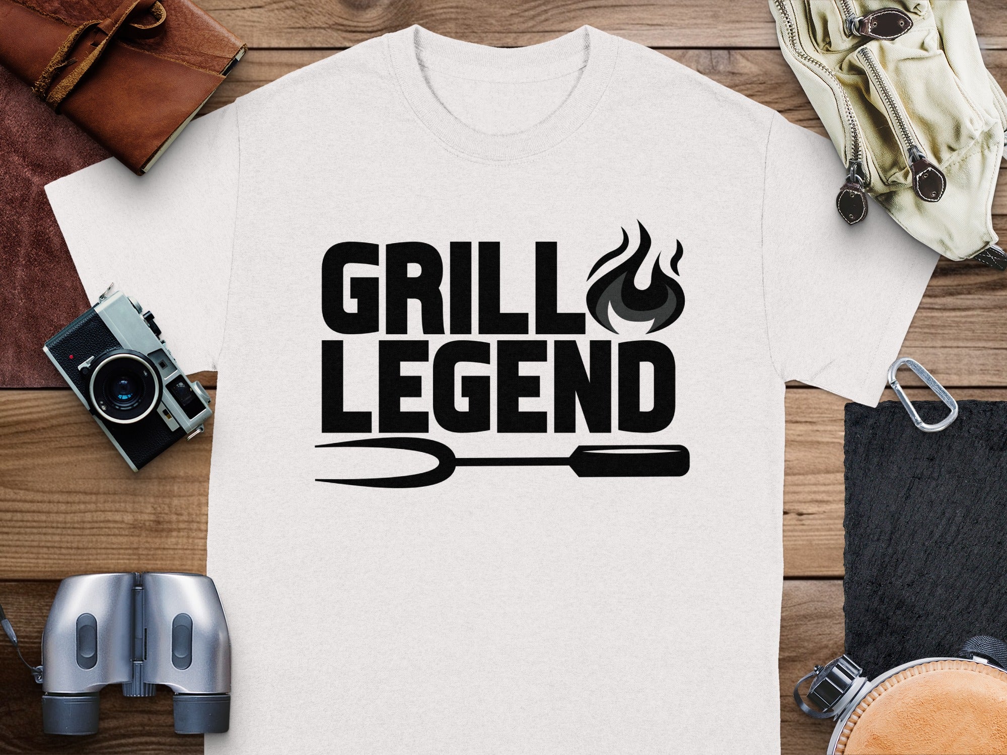 White t-shirt with black text "GRILL LEGEND" and grilling fork graphic.
