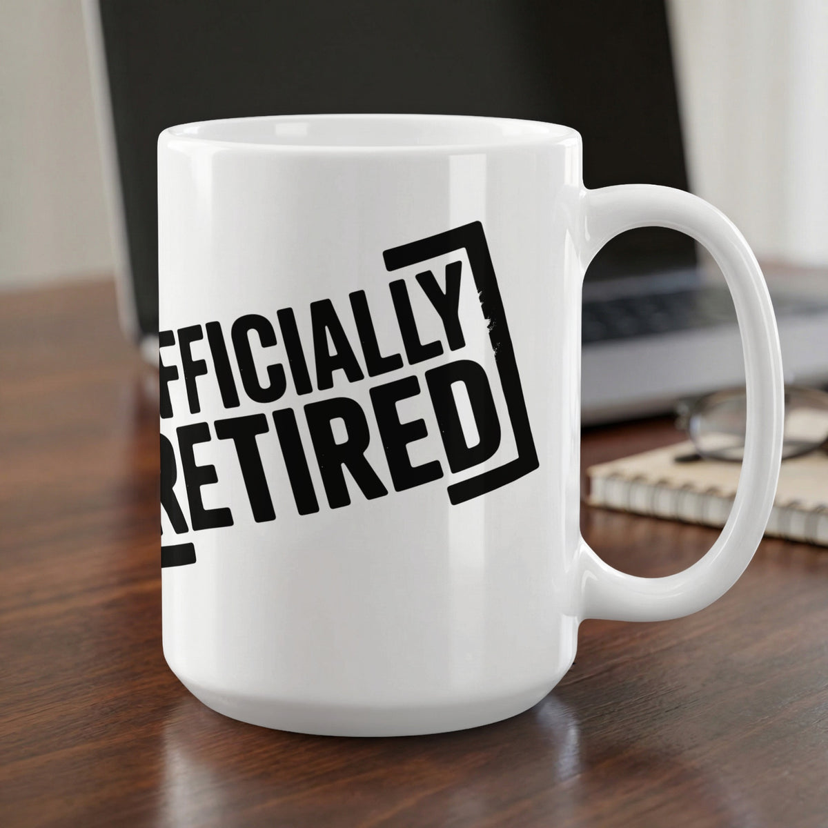 White mug with black text reading "OFFICIALLY RETIRED".