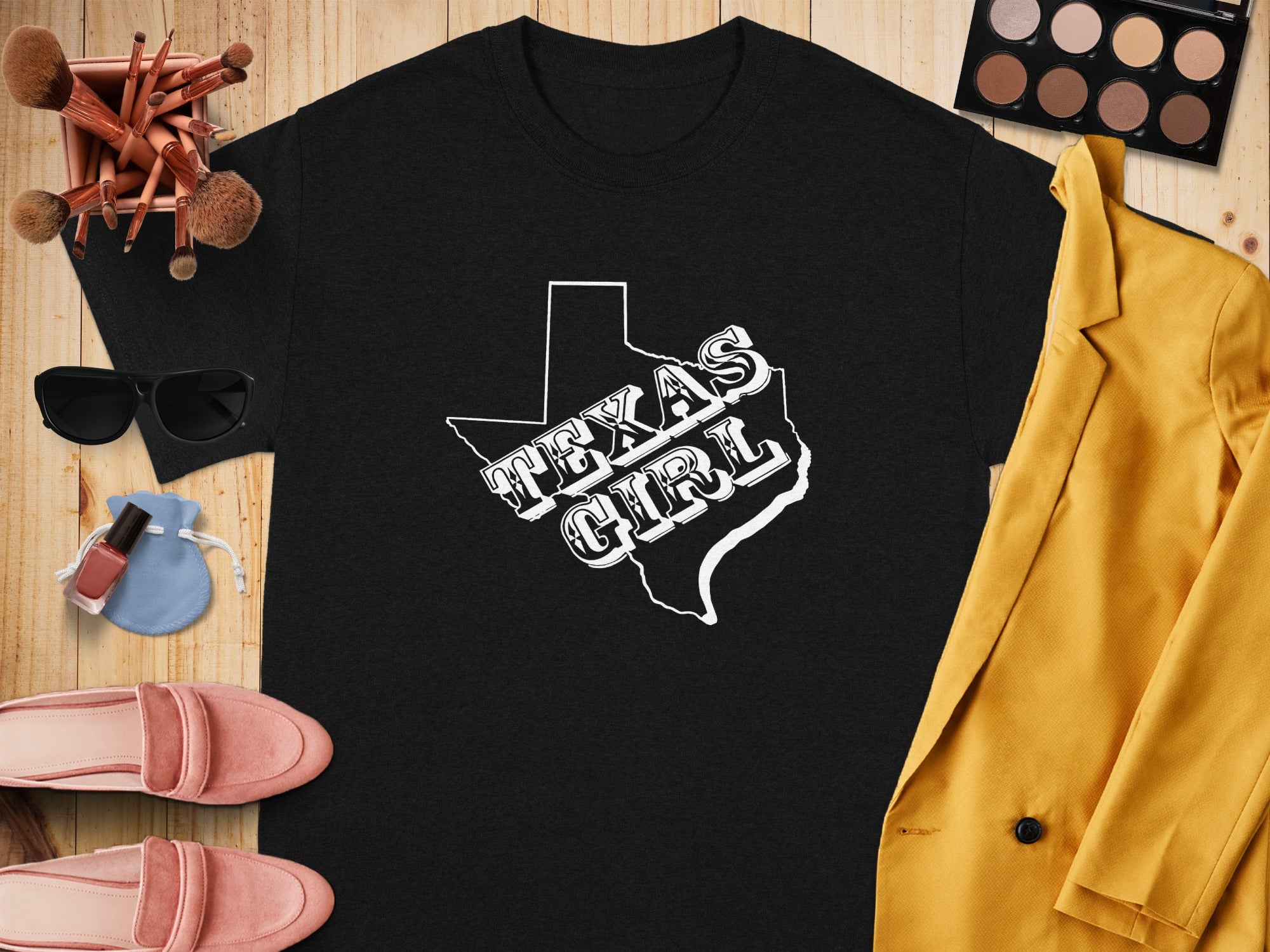Black t-shirt with white "Texas Girl" text inside Texas outline.