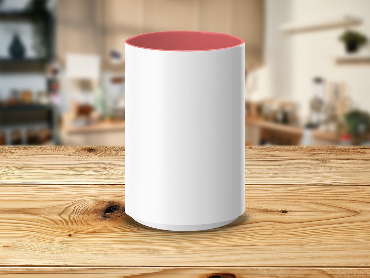 White mug with pink interior on a wooden table, blurred background.