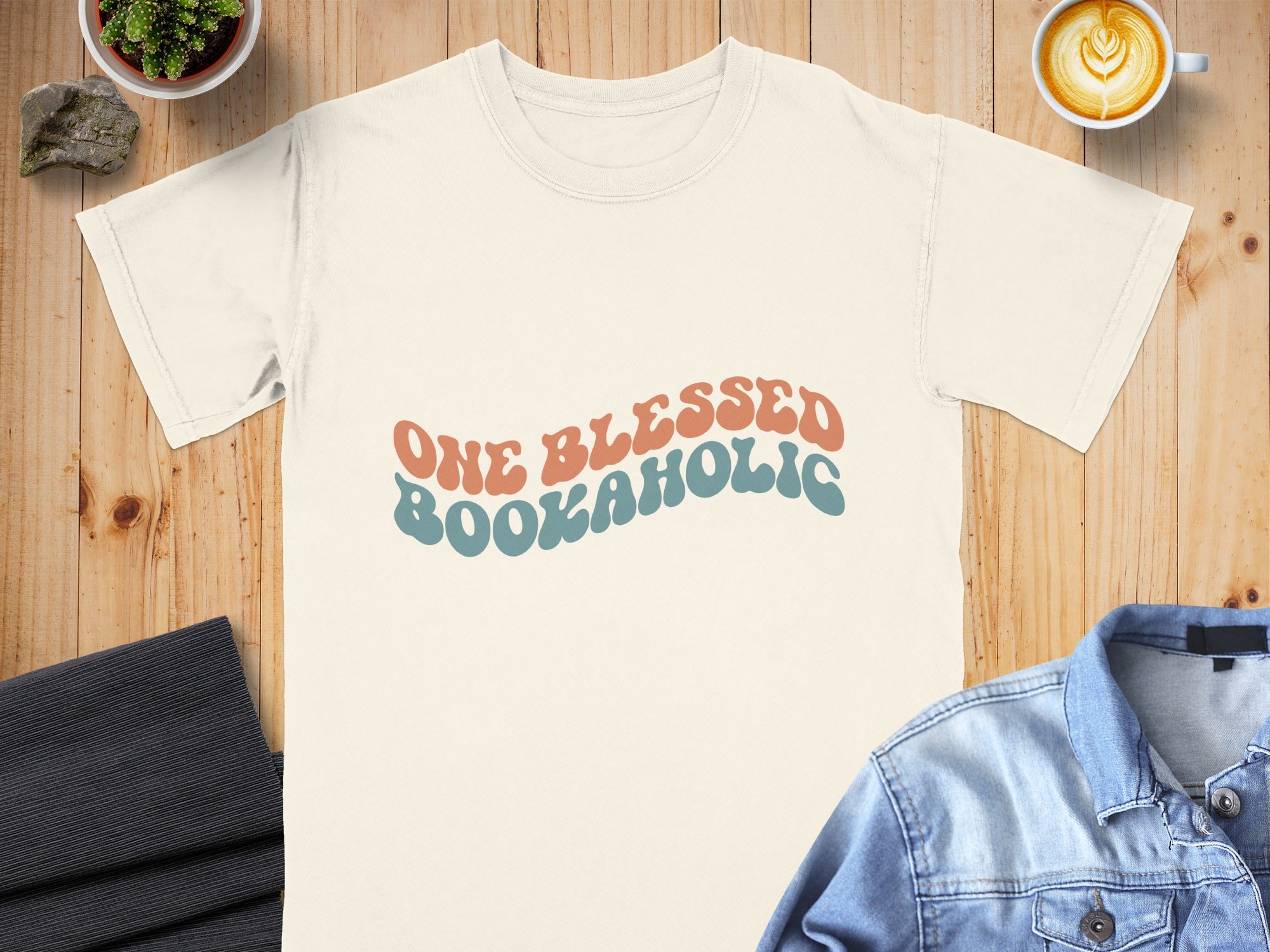 Cream t-shirt with "One Blessed Bookaholic" in retro font.