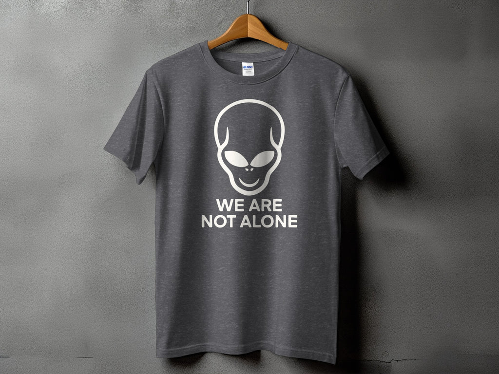 Grey t-shirt with white alien graphic and text "WE ARE NOT ALONE".