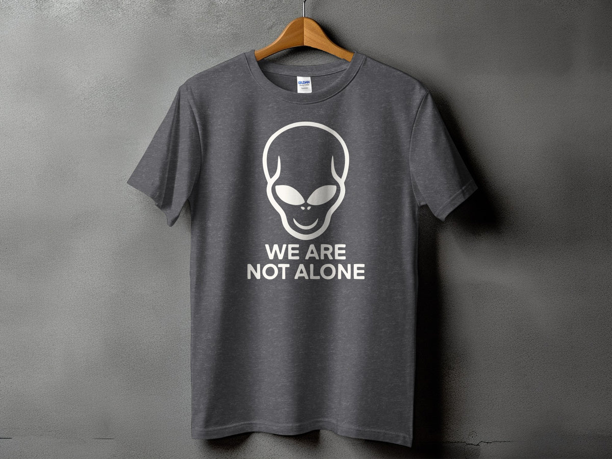 Grey t-shirt with white alien graphic and text "WE ARE NOT ALONE".
