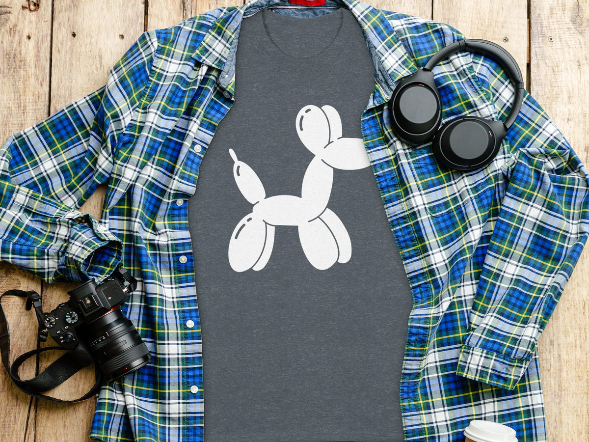Dark gray t-shirt with white balloon dog graphic, plaid shirt, headphones, and camera.
