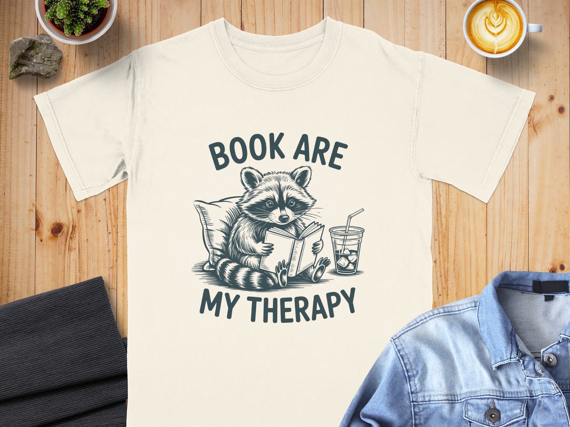 T-shirt with raccoon reading a book and text "Book Are My Therapy".