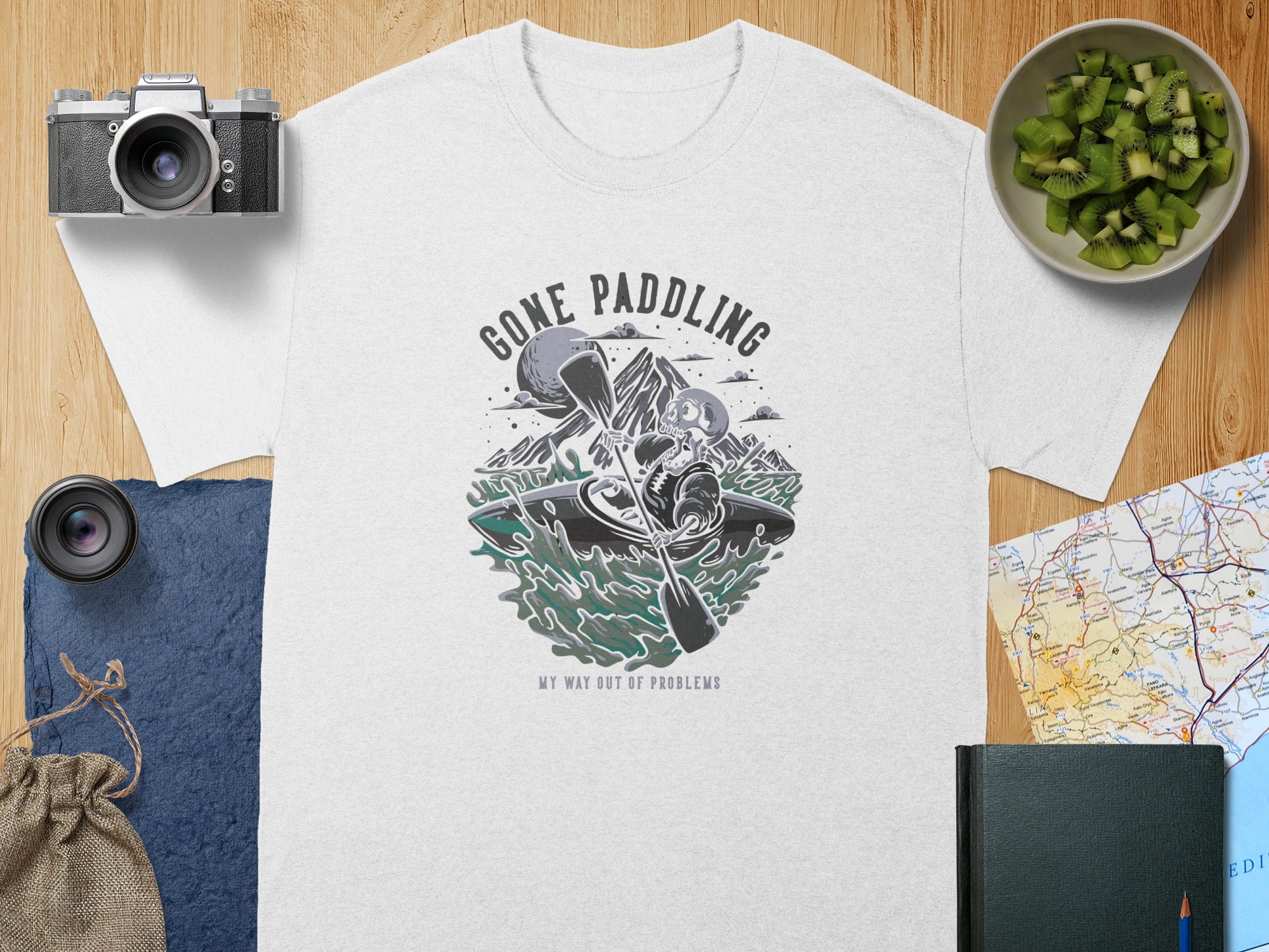White t-shirt with "Gone Paddling My Way Out of Problems" graphic.
