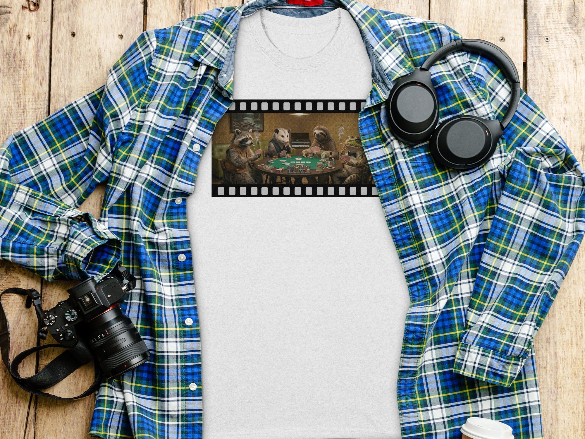 Shirt with film strip graphic of animals playing poker, headphones, camera, and plaid shirt.