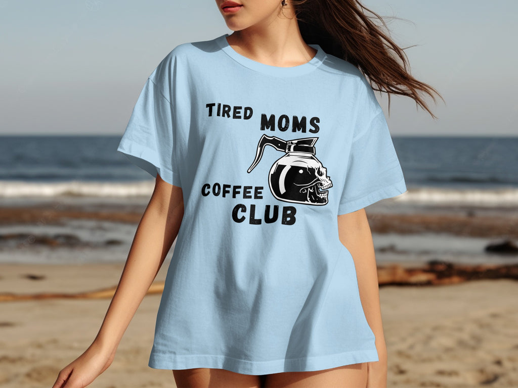 Light blue t-shirt with "Tired Moms Coffee Club" text and skull coffee pot graphic.