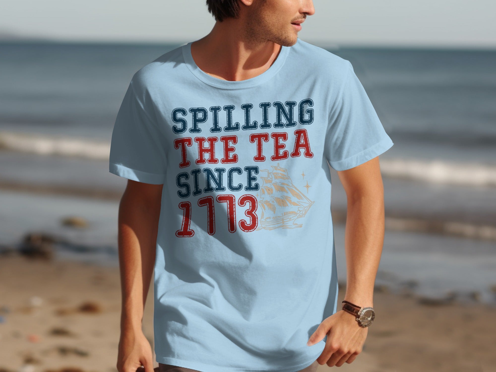 Light blue t-shirt with "Spilling The Tea Since 1773" and a ship illustration.