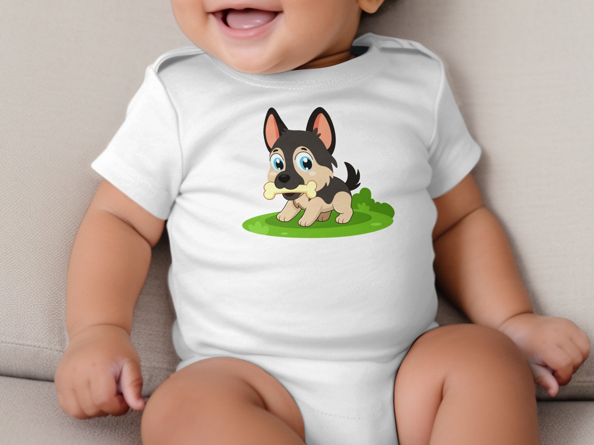 White baby onesie with a cartoon German Shepherd puppy holding a bone on green grass.