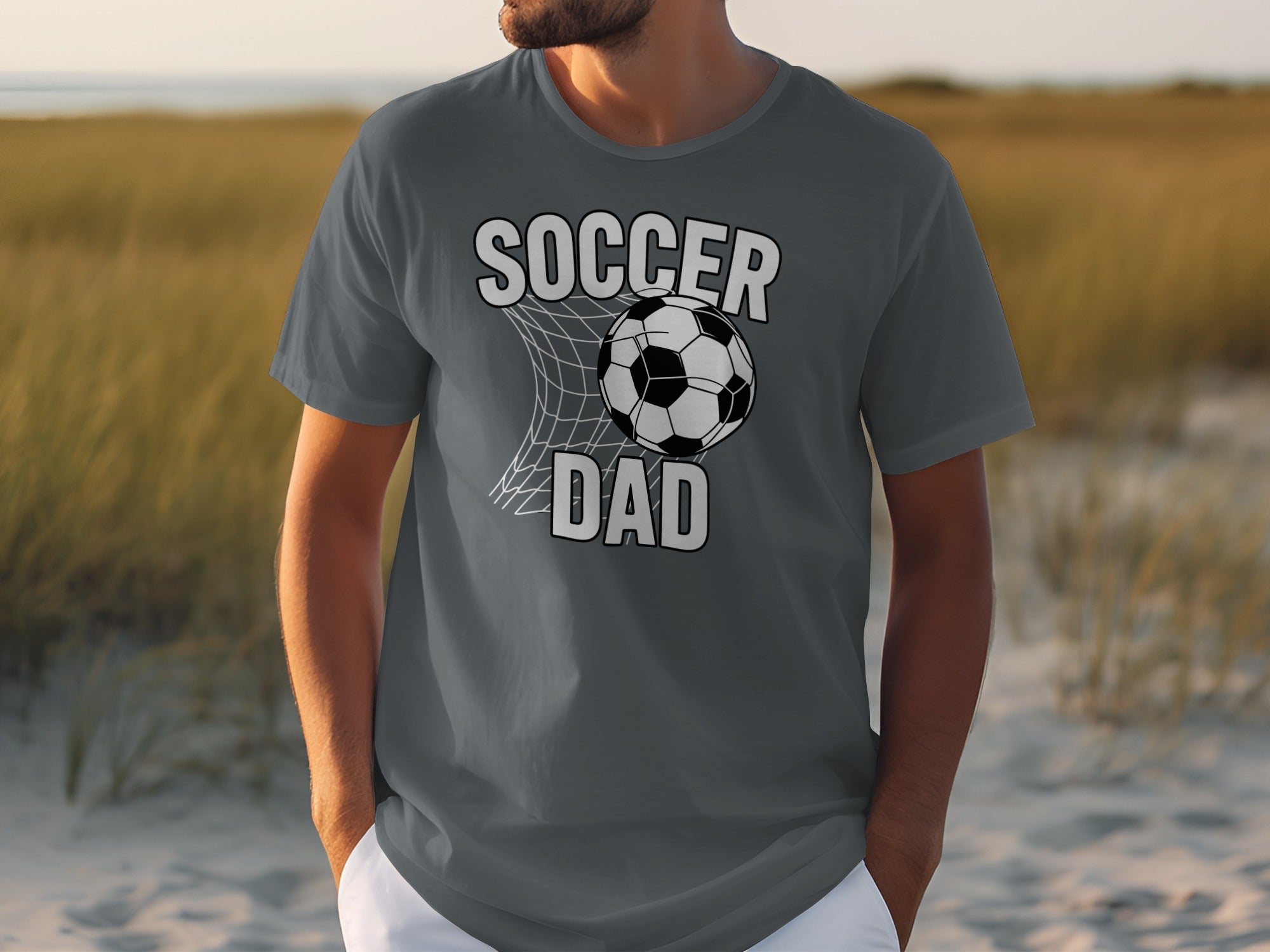 Grey t-shirt with "Soccer Dad" text and soccer ball in net design.