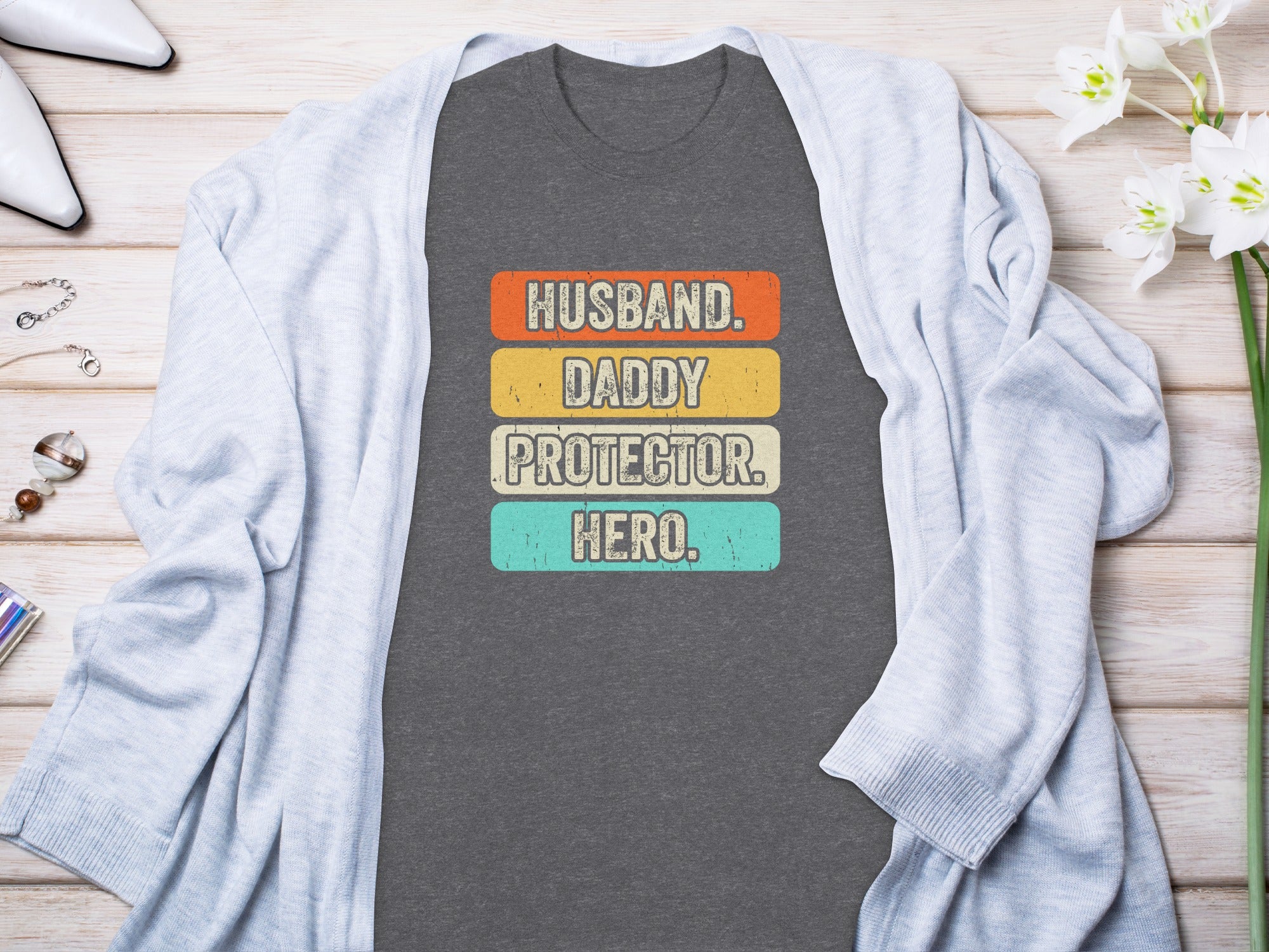 Husband, Daddy, Protector, Hero text on charcoal t-shirt with light blue cardigan.