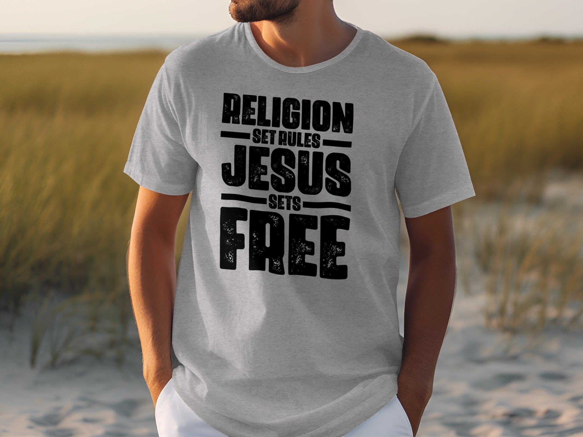 Grey t-shirt with black text: RELIGION SET RULES JESUS SETS FREE