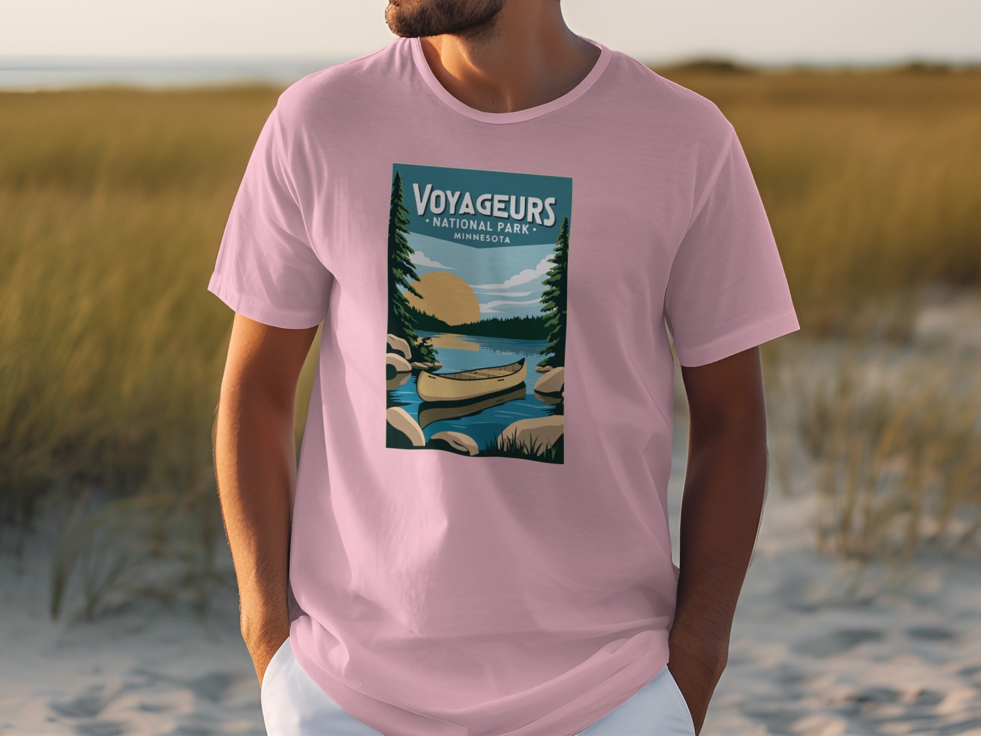 Voyageurs National Park Minnesota graphic on a pink t-shirt with canoe and sunset.