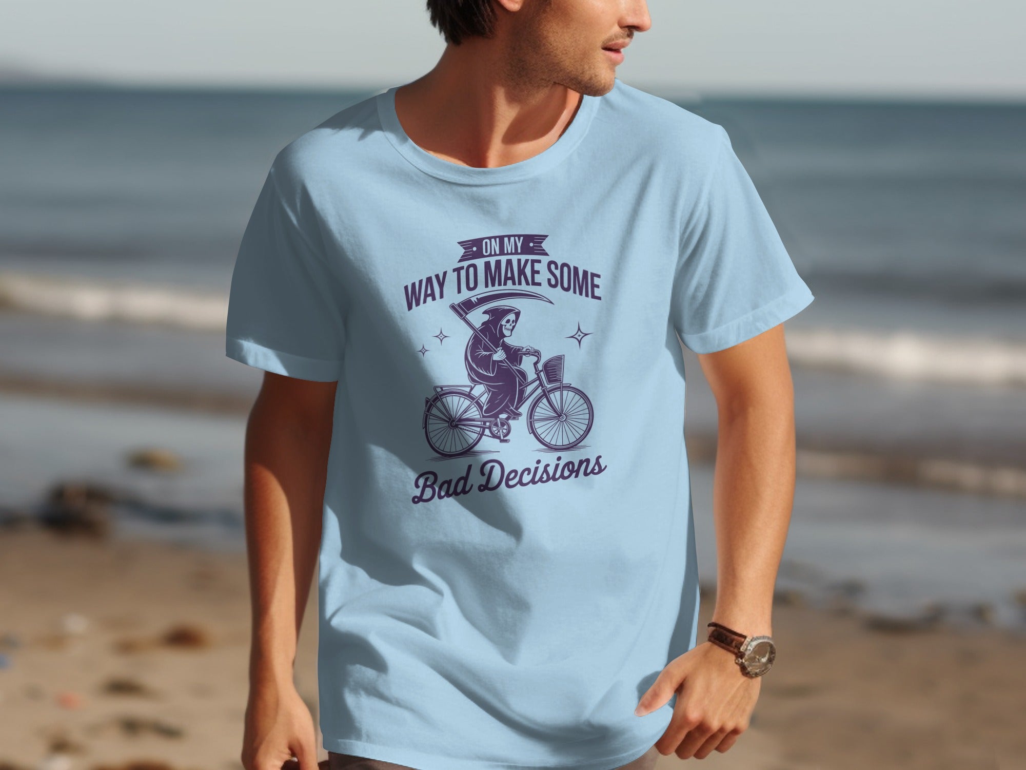 Light blue t-shirt with Grim Reaper on bicycle graphic and text reading "On My Way To Make Some Bad Decisions".