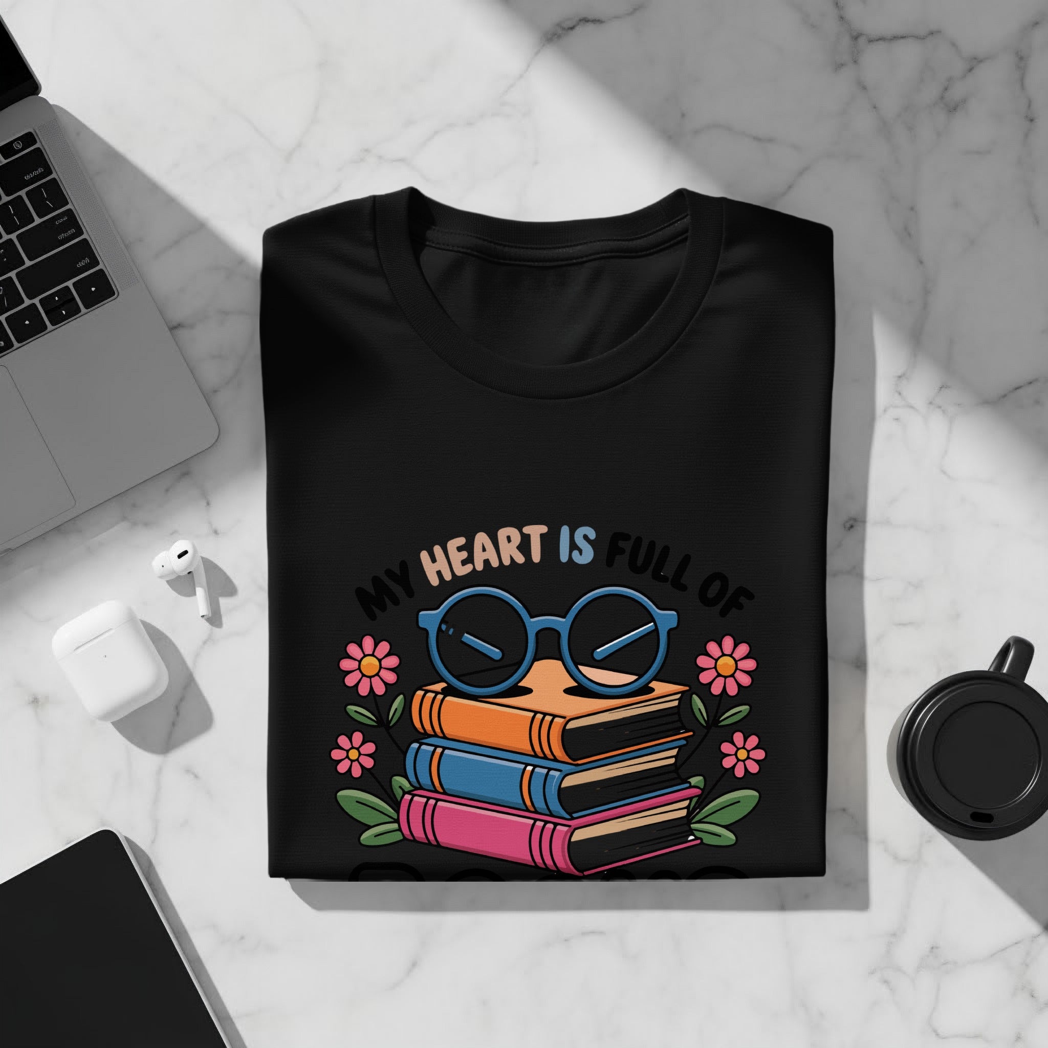 Black t-shirt with stacked books, glasses, and flowers graphic reading "My Heart is Full of".