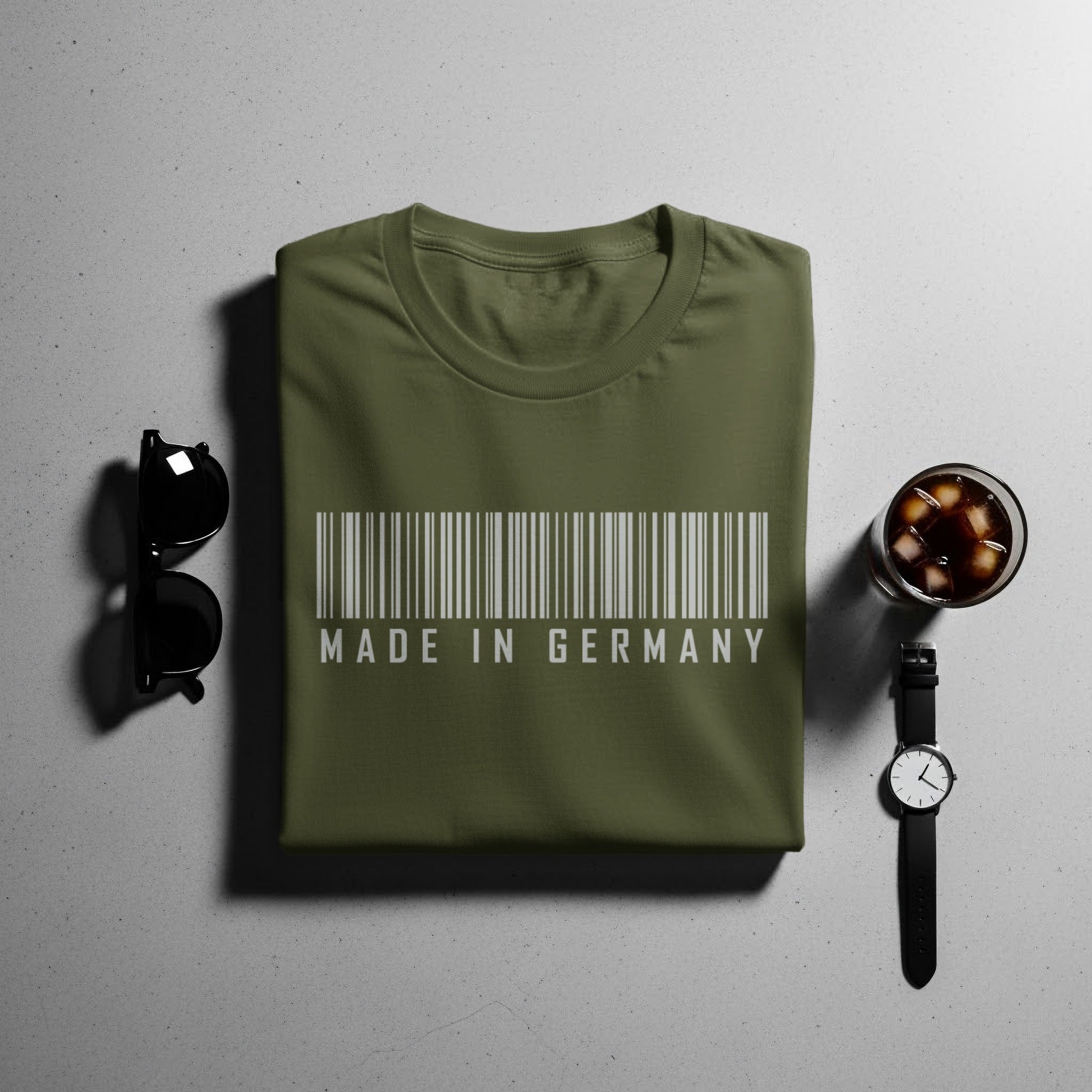 Green t-shirt with barcode and "MADE IN GERMANY" text.