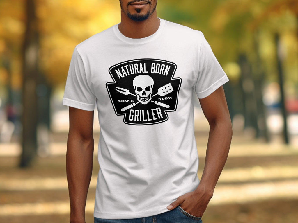 White t-shirt with "Natural Born Griller" skull and barbecue tools graphic.