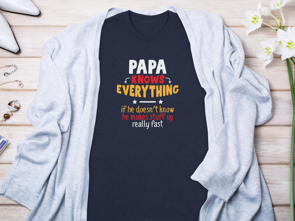 Dark blue t-shirt with "Papa Knows Everything" text.