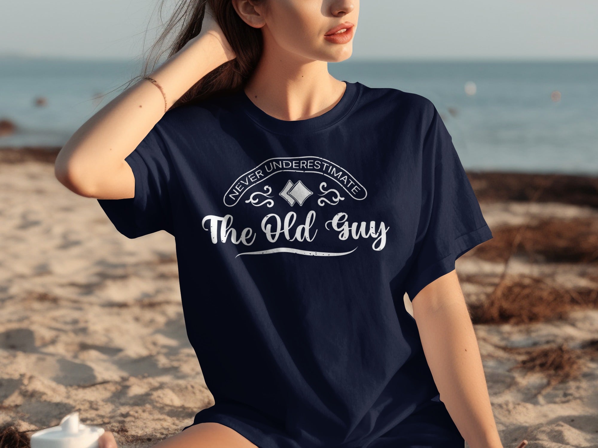 Navy t-shirt with white text "Never Underestimate The Old Guy"