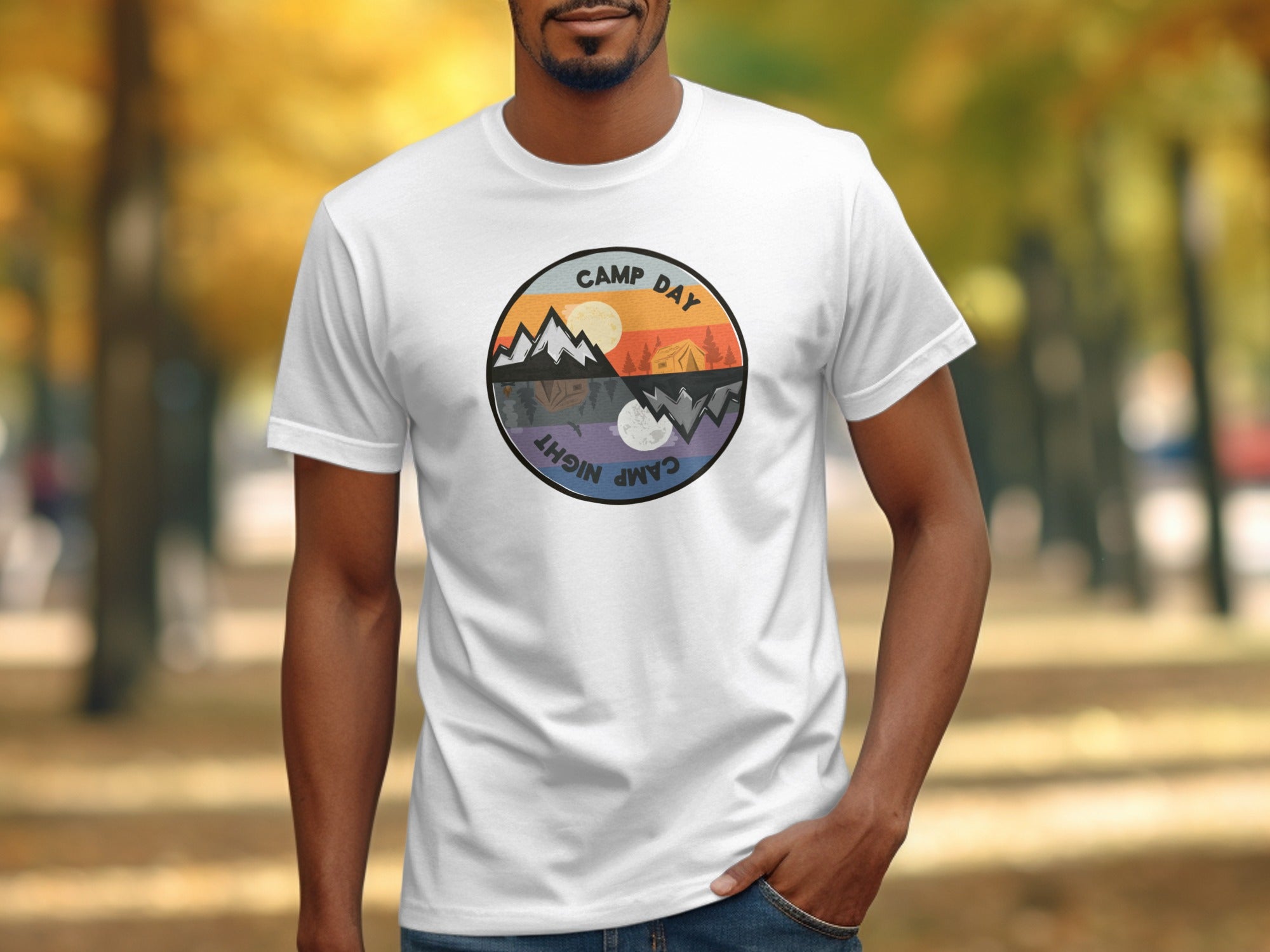 White t-shirt with a circular graphic of a split scene: day and night camping.