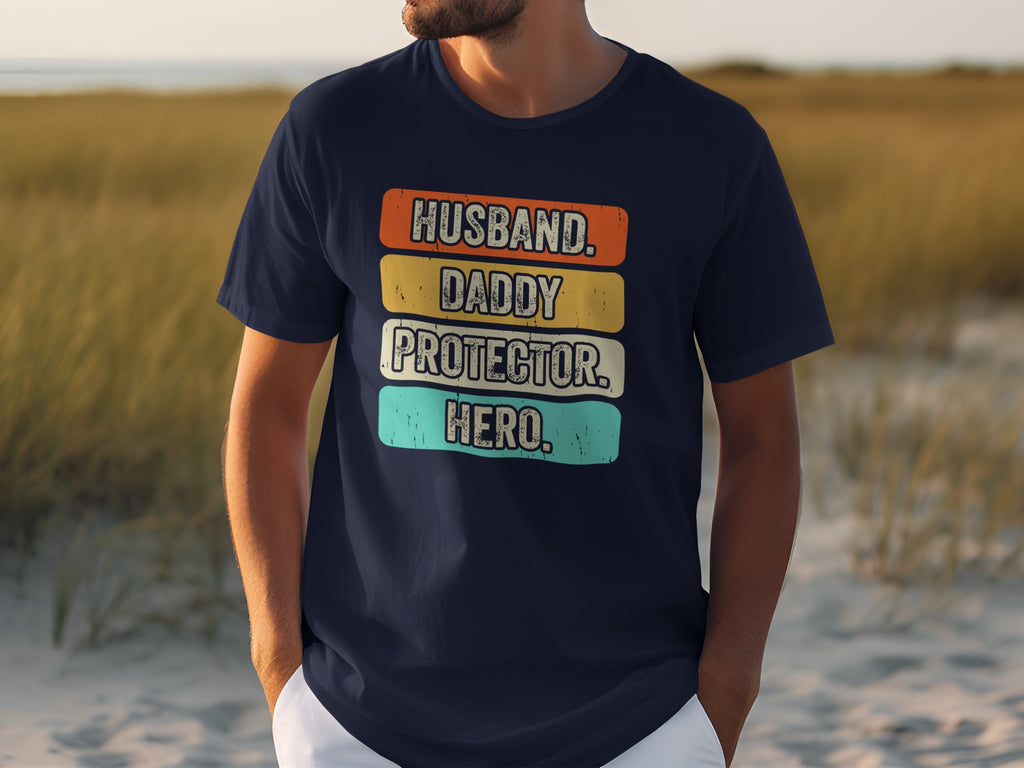 Navy t-shirt with "Husband, Daddy, Protector, Hero" text in colorful retro stripes.