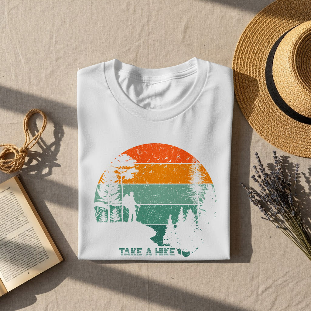White t-shirt with vintage sunset, hikers, trees, and "Take a Hike" text.