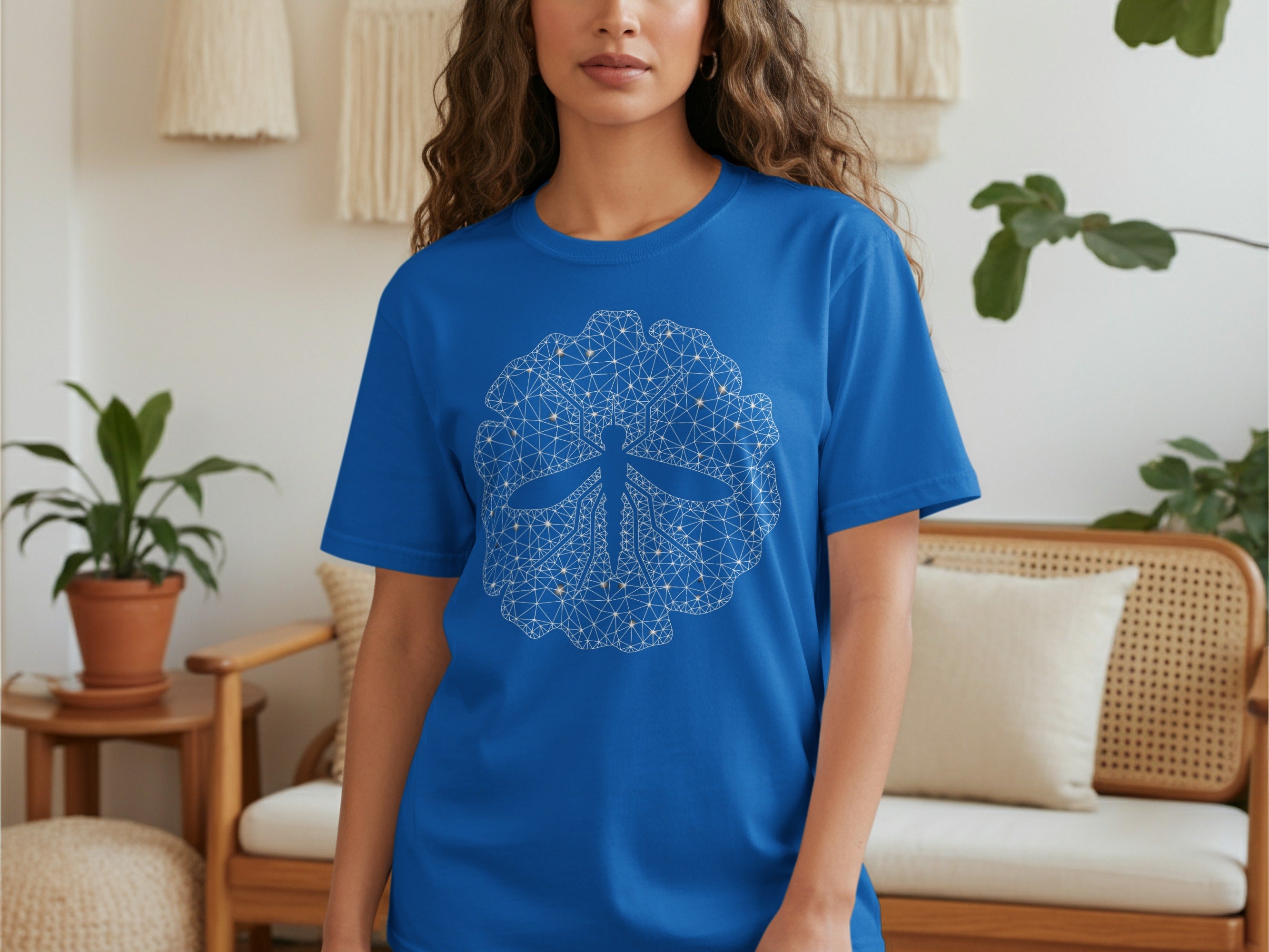 Blue t-shirt with a white geometric dragonfly design on the chest.