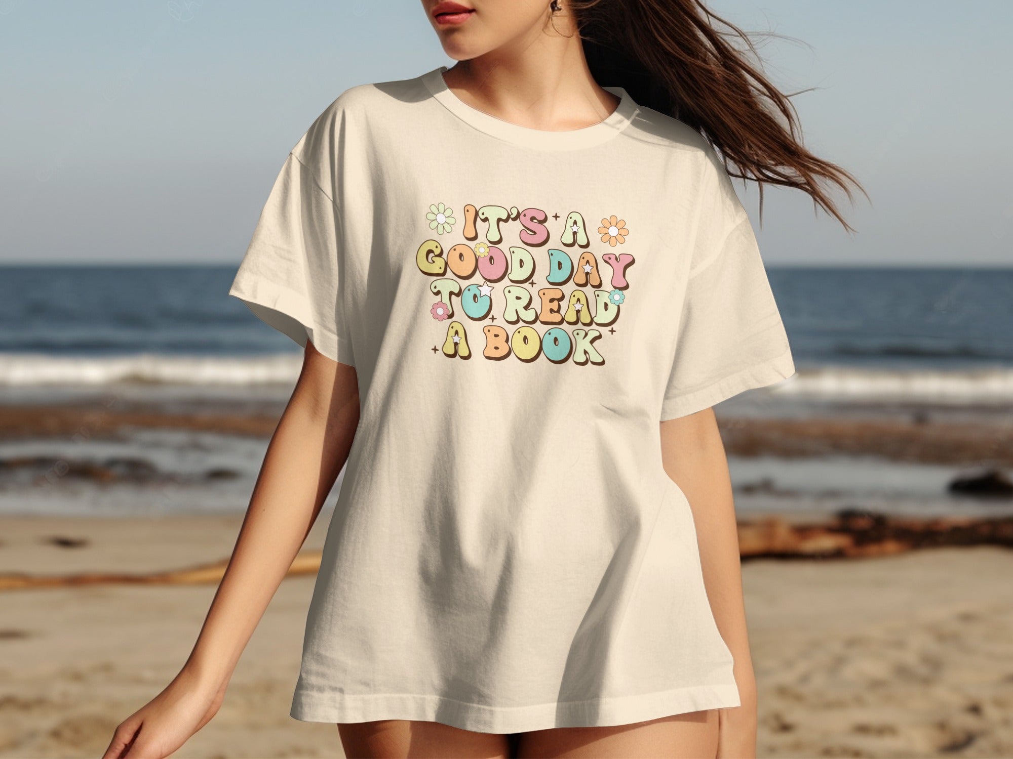 Cream t-shirt with colorful retro text that says "It's a good day to read a book."
