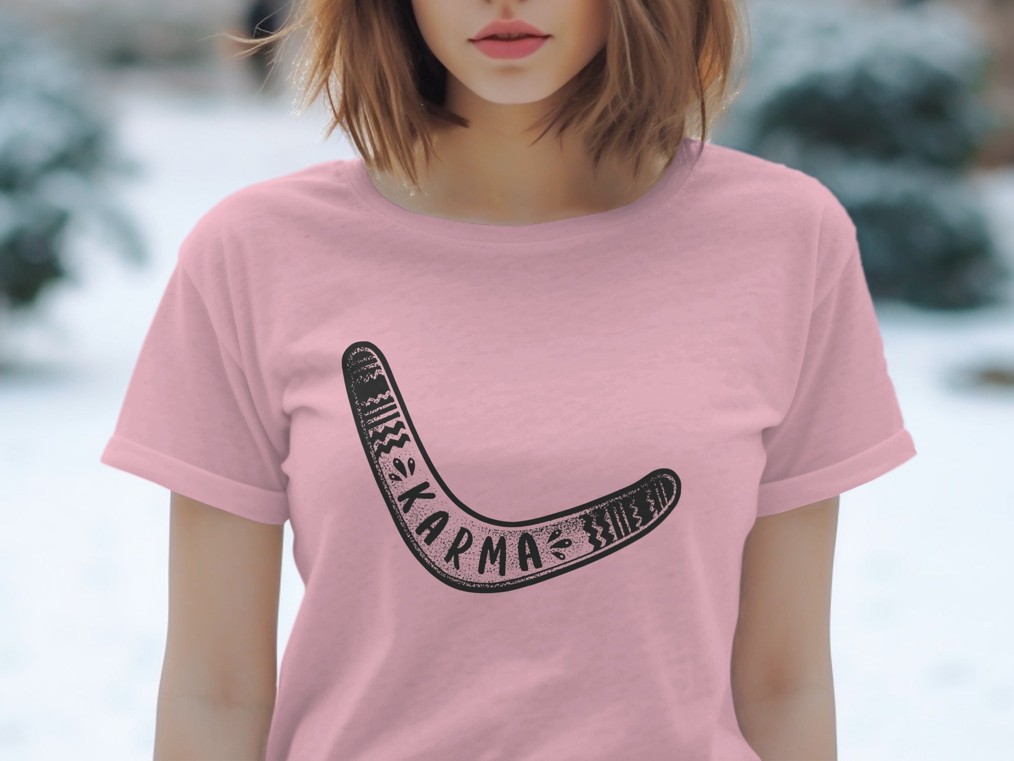 Pink t-shirt with a black boomerang graphic and the word "karma" on it.