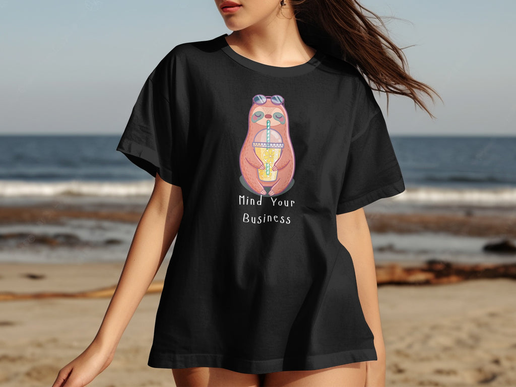Black t-shirt with a cartoon sloth wearing sunglasses drinking from a cup with the text "Mind Your Business."