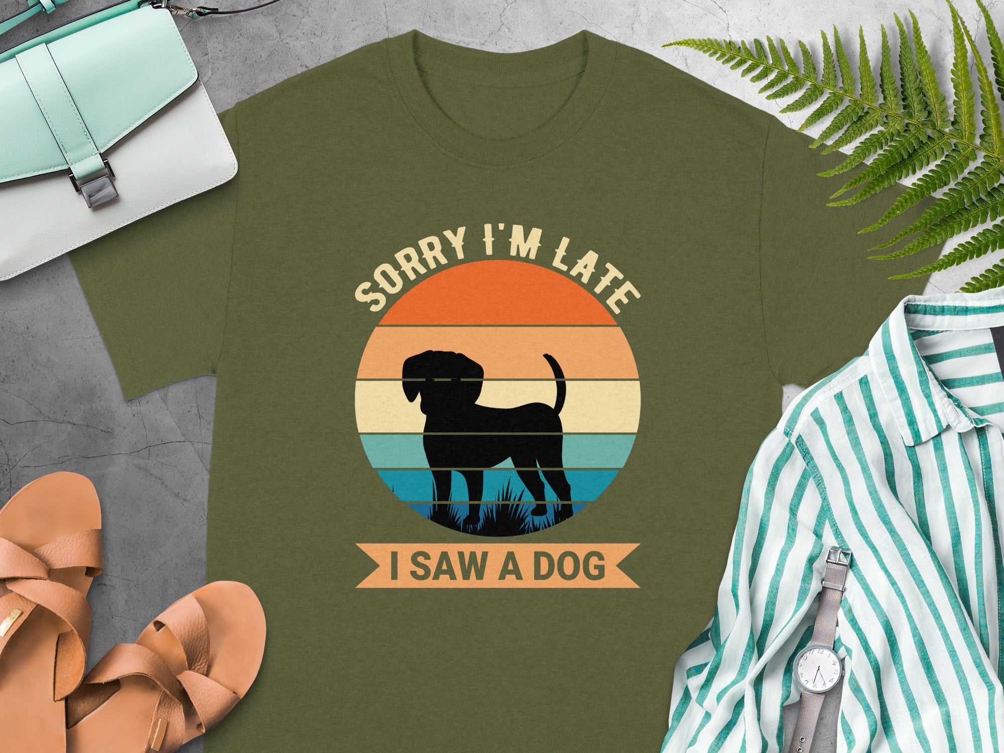 Olive green t-shirt with a circular graphic of a black dog and text "SORRY I'M LATE I SAW A DOG".