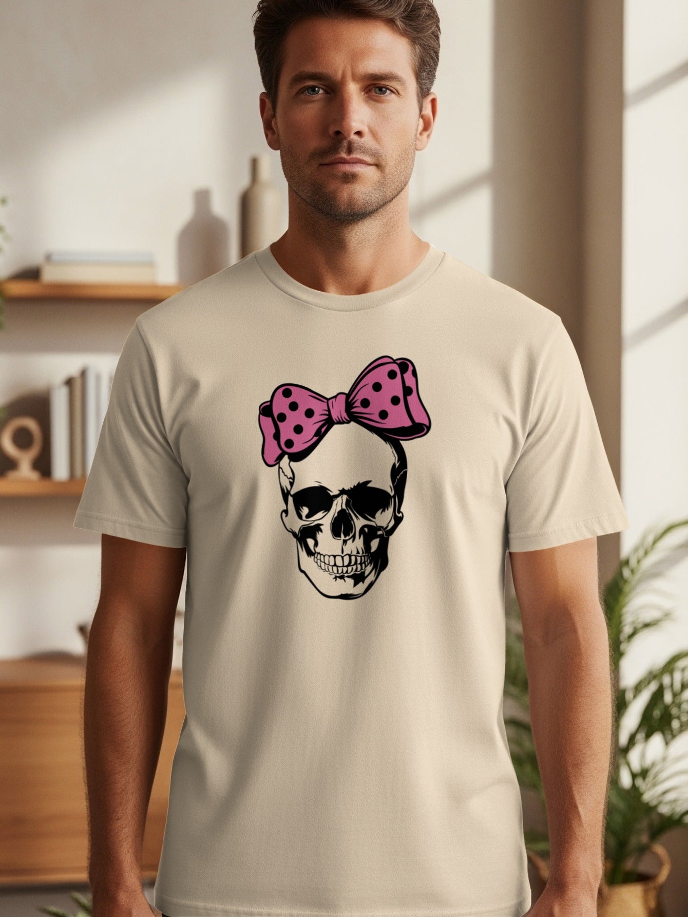 Skull with pink polka dot bow graphic on a cream t-shirt.