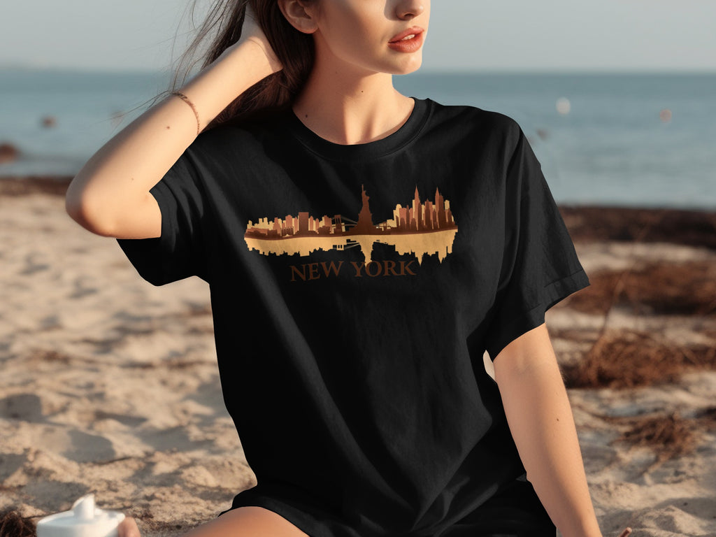 Black t-shirt with New York skyline and text on a beach.