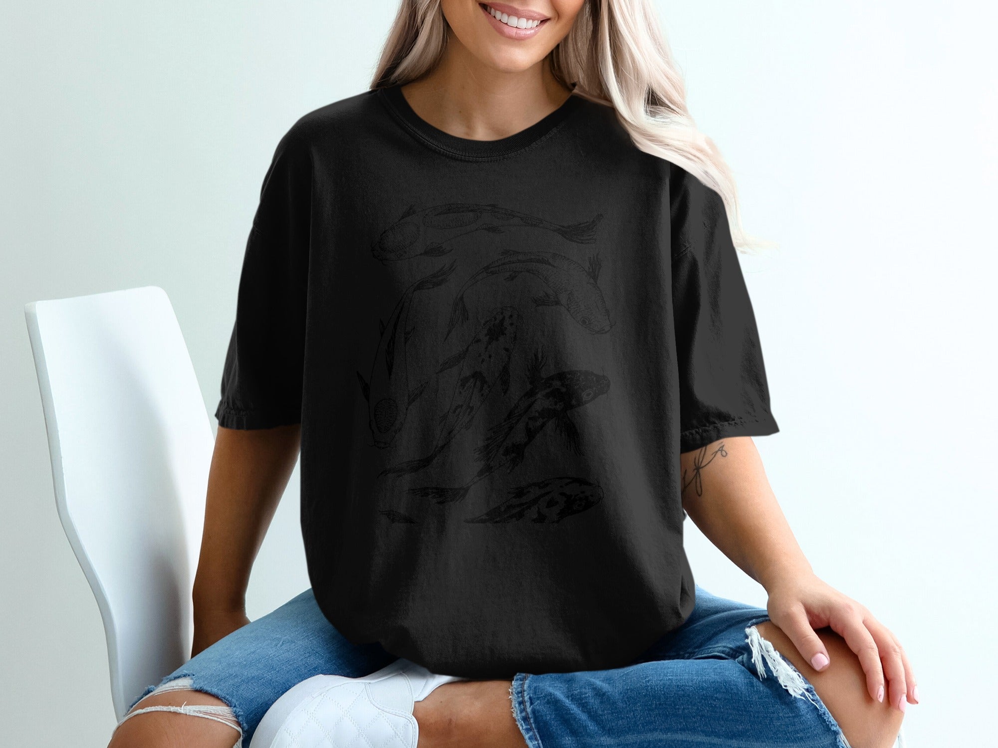 Black t-shirt with a dark line drawing of several koi fish on the front.