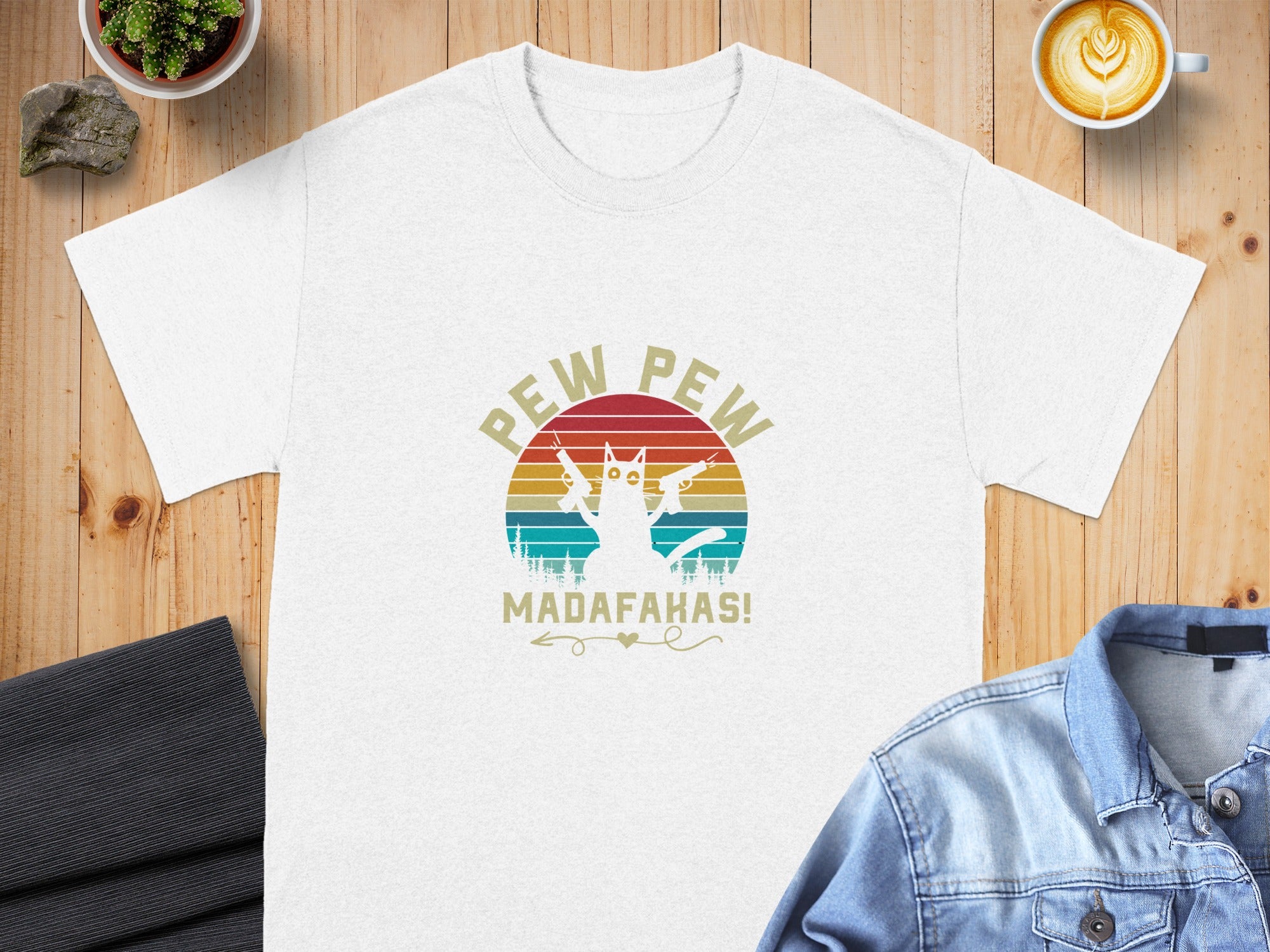 White t-shirt with retro graphic of a cat holding guns and text "PEW PEW MADAFAKAS!".