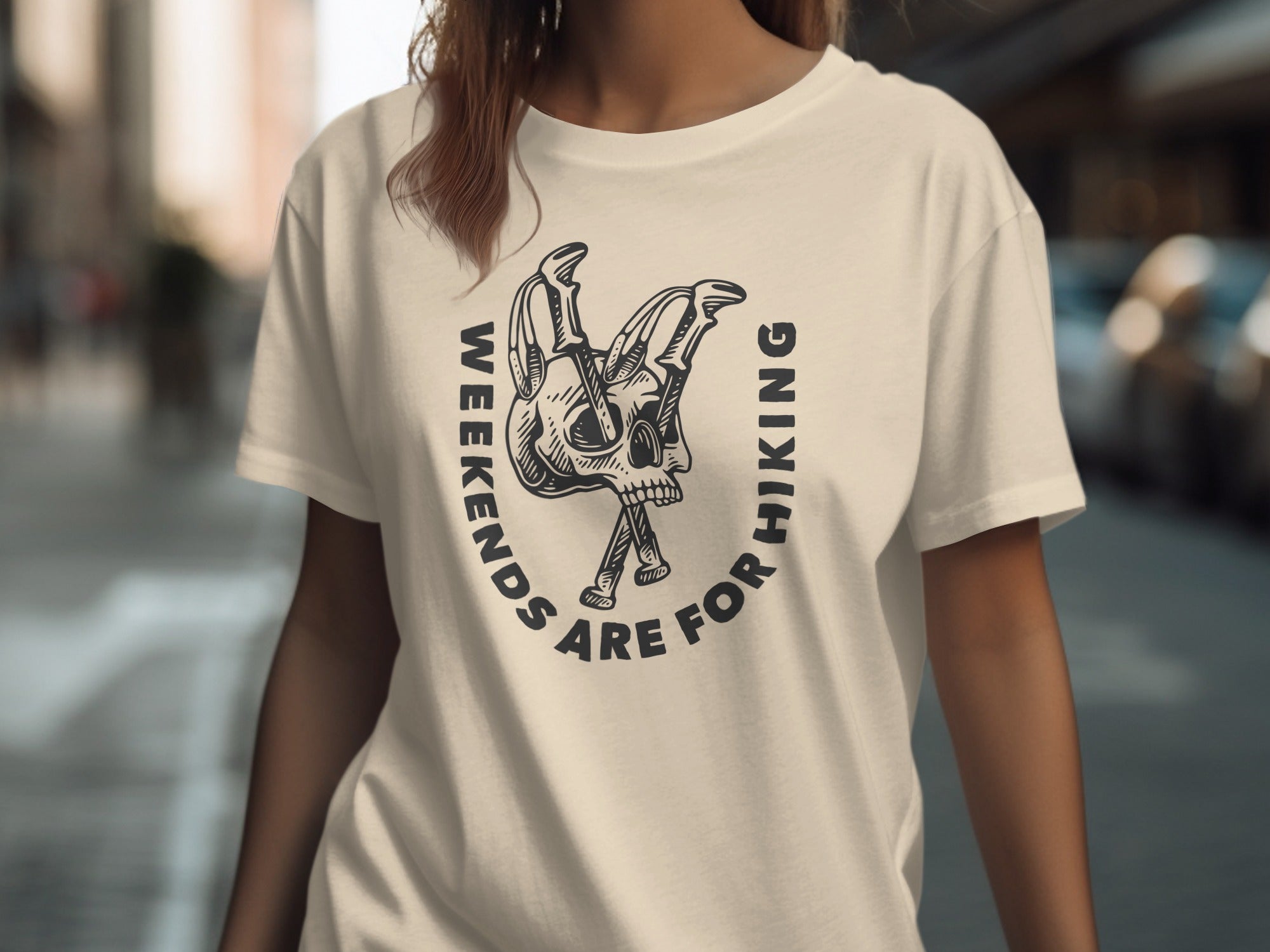 Cream t-shirt with black graphic of skull and text "Weekends are for hiking".
